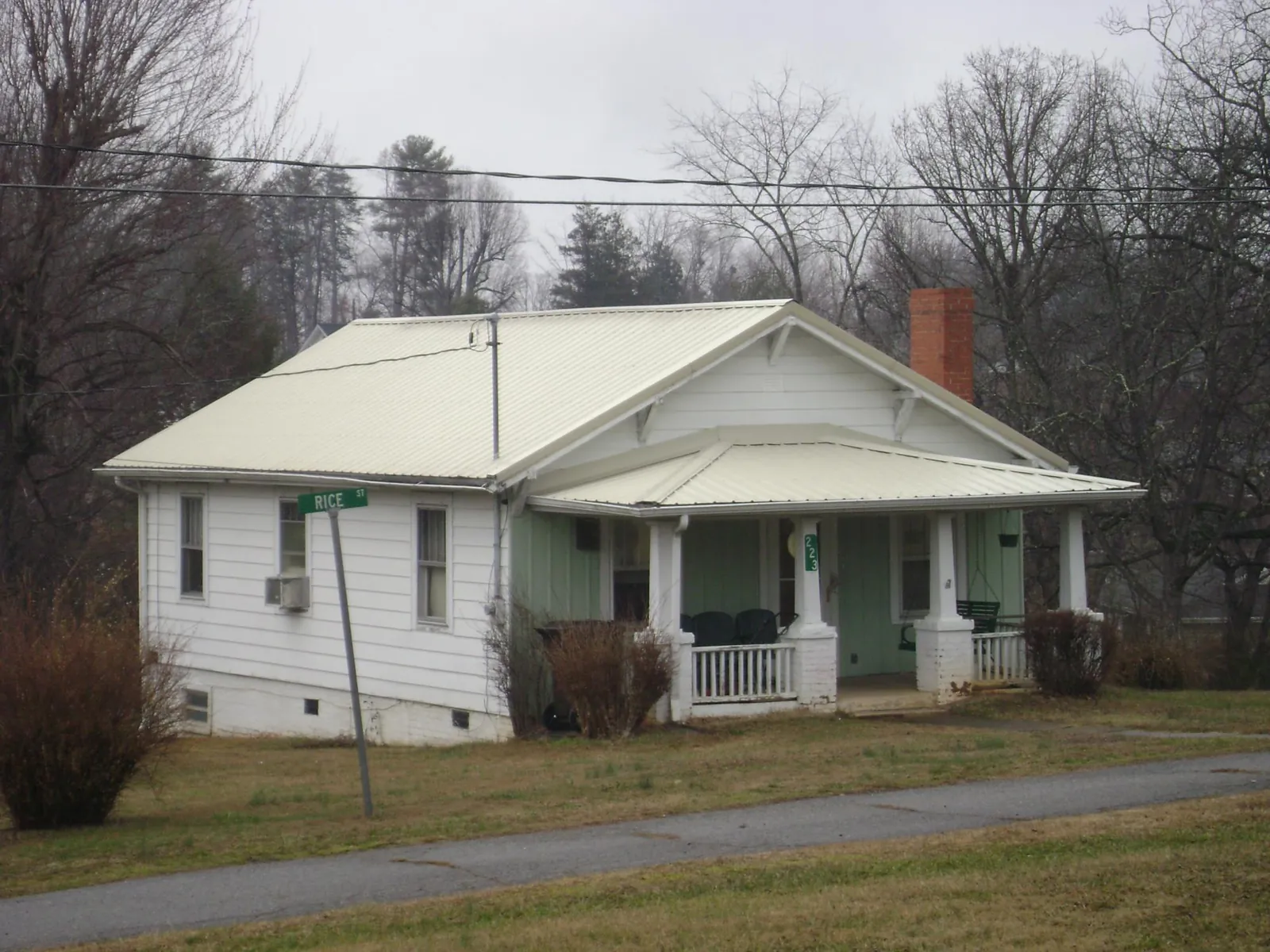 White metal roof on a craftsman bungalow at a street corner in Bussey