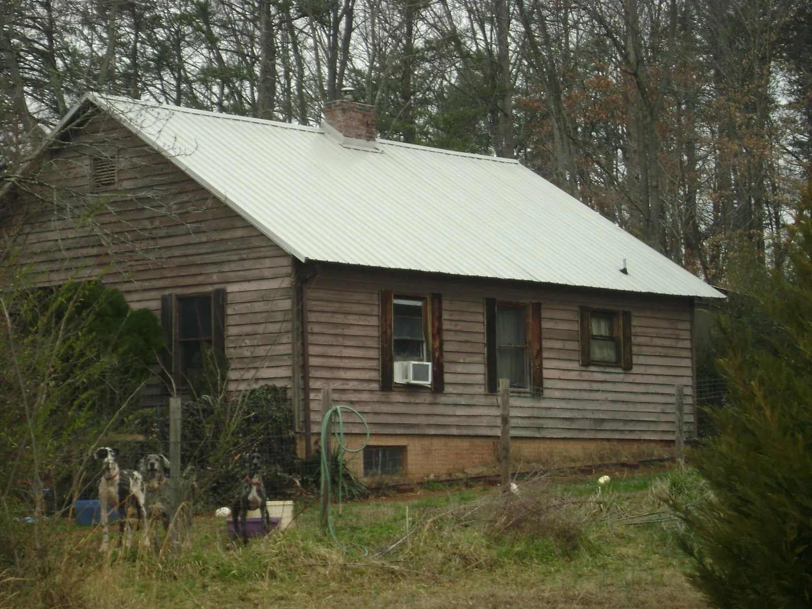 White metal roof on an old wood sided farmhouse, from a Metal Roof Installation job in Bussey